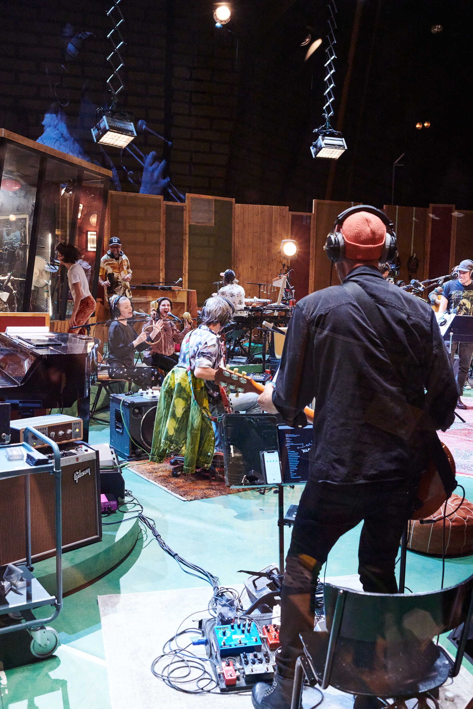 Flera personer i en studio spelar in musik tillsammans. 